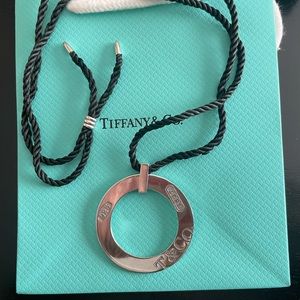 Lovely large Tiffany & Co 1837 circle pendant with adjustable silk cord .